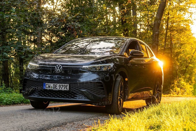 Front view of a car on a road in the forest during sunset, electric car, VW ID5, Gechingen, Black Forest, Germany, Europe