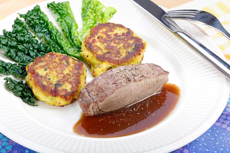 Swabian cuisine, medallions of wild boar with savoy cabbage cakes, meat dish, roasted, hearty, home cooking, typical Swabian, arranged on a plate, traditional cuisine reinterpreted, food photography, studio, Germany, Europe