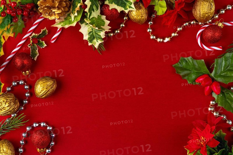 Christmas decoration frame with gold and red elements on a red background, copy room
