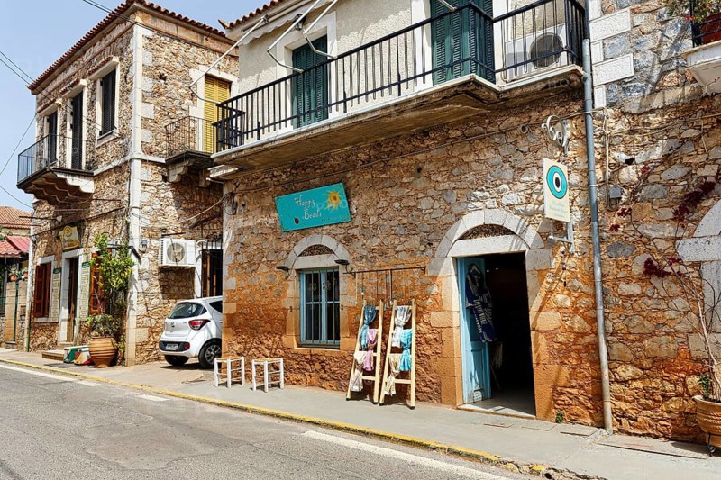 Typical stone houses with shops, souvenir shops, Stoupa, former fishing village, Mani, Greece, Europe