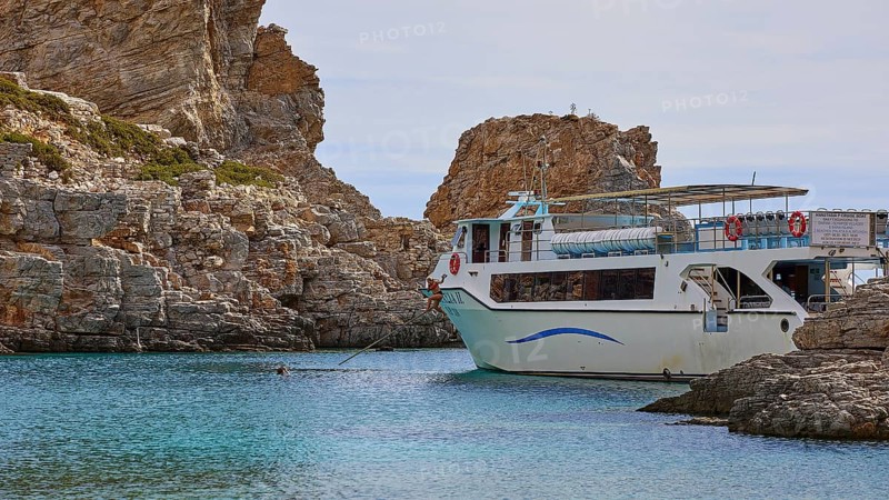 Palatia Beach, Palatia, A boat anchored near a rocky shore in clear blue water under a calm sky, boat tour Saria, Saria Island, Karpathos, Dodecanese, Greek Islands, Greece, Europe