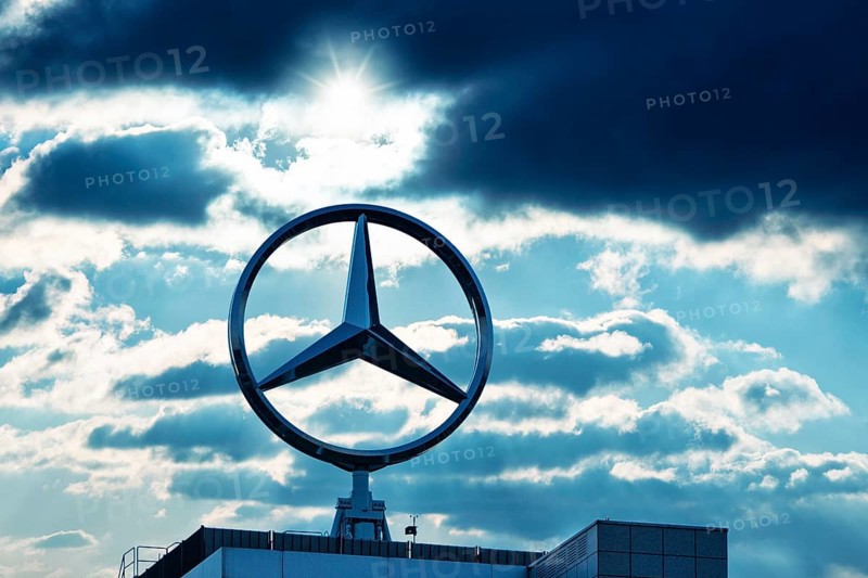 Symbolic image, Dark clouds at Mercedes, Mercedes logo on a building surrounded by dramatic cloud formations and rays of light in the blue sky, Stuttgart-Untertürkheim, Baden-Württemberg, Germany, Europe