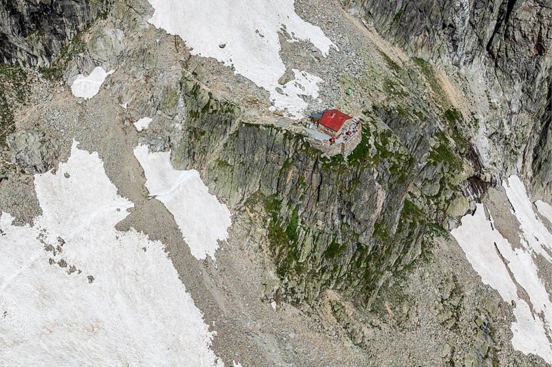 Aerial view of mountain hut Cabane de l'A Neuve, located on a steep rock formation, near La Fouly, Val de Ferret, Valais, Switzerland, Europe