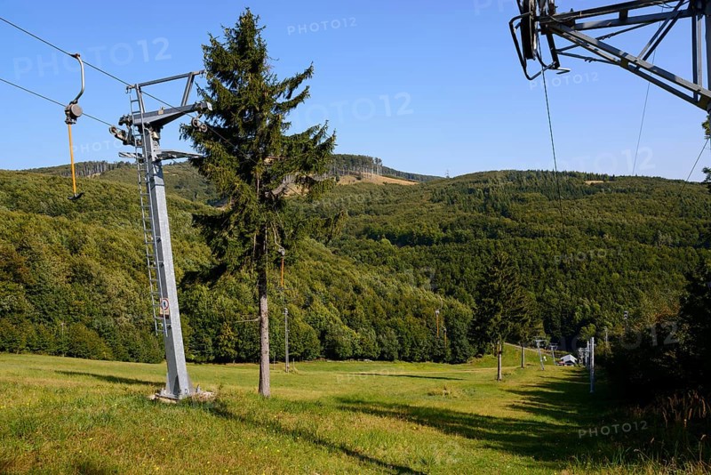 A cable car leads over a wooded hill under a clear blue sky in summer, Pezinska Baba ski resort, Pezinská Baba, Little Carpathians, Malé Karpaty, Pezinok, Slovakia, Europe