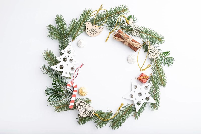 Christmas or New Year wreath composition. Decorations, stars, bells, fir and spruce branches, on white background. Top view, copy space, flat lay