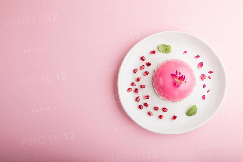 Pink mousse cake with strawberry on a pastel pink background. top view, flat lay, copy space