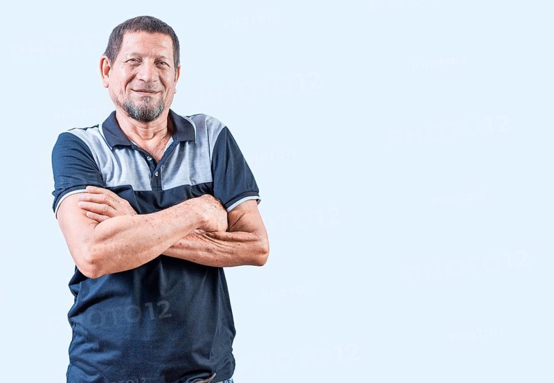 Portrait of smiling senior man with arms crossed isolated. Smiling latin old man with arms crossed, casual on isolated background