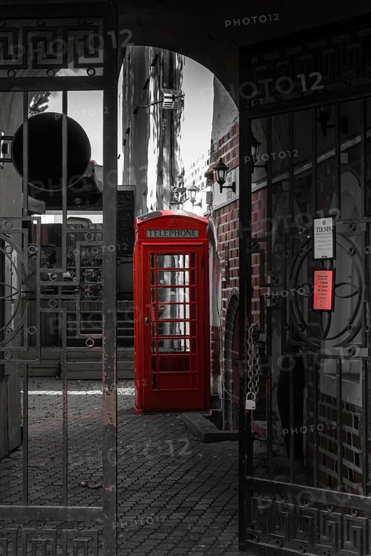 Old red phone booth in the courtyard