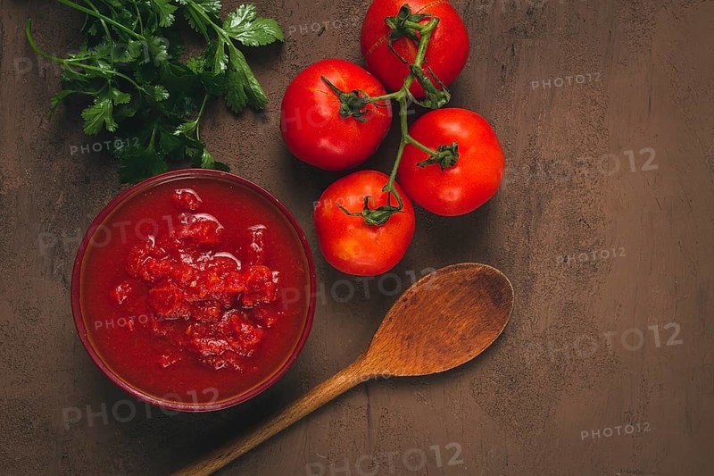 Tomatoes in their own juice, sliced, tomato sauce, tomatoes, in a cup, top view, close-up, no people