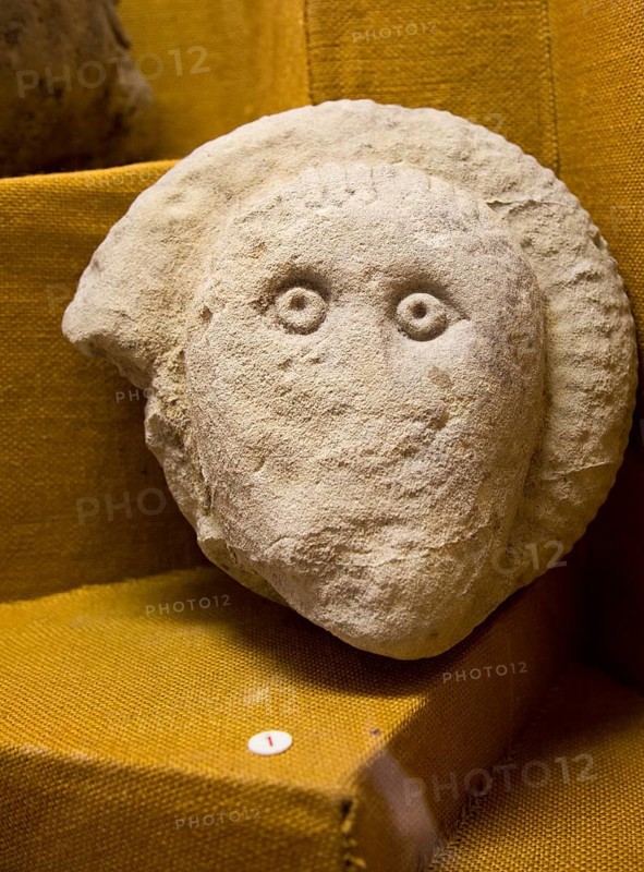 Human face carved onto an ammonite, using the natural form of the fossil. Found in Great Bedwyn. With permission of Wiltshire Museum, Devizes, England, UK