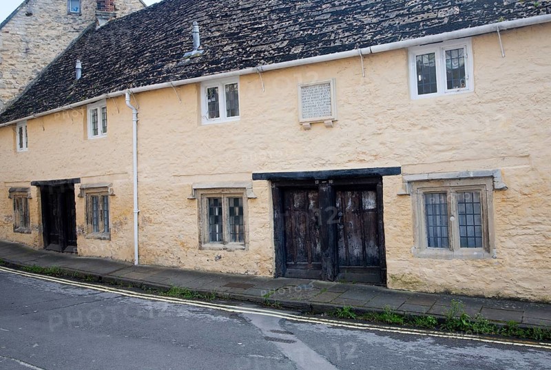 Row of historic almshouses in Kingsbury Street, Calne north Wiltshire, England erected by Dr John Tounson, vicar of Bremhill, in 1682