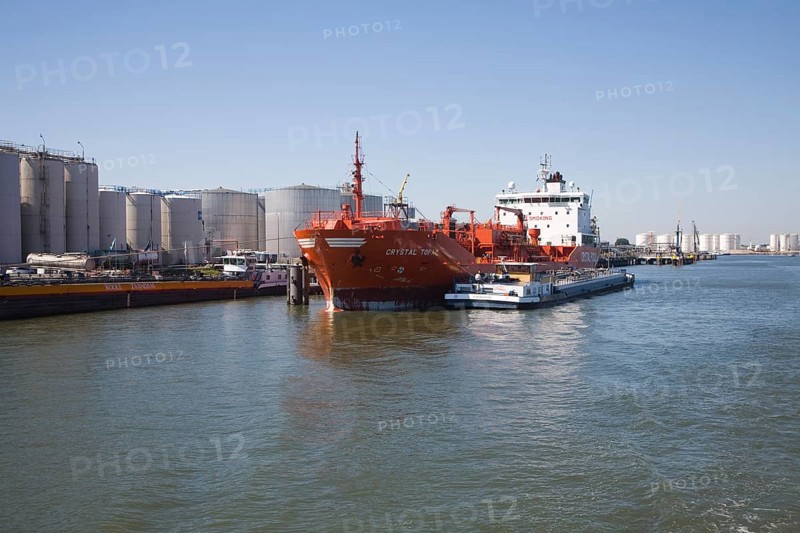 Chemical oil bulk carrier ship 'Crystal Topaz' next to storage tanks, Port of Rotterdam, Netherlands