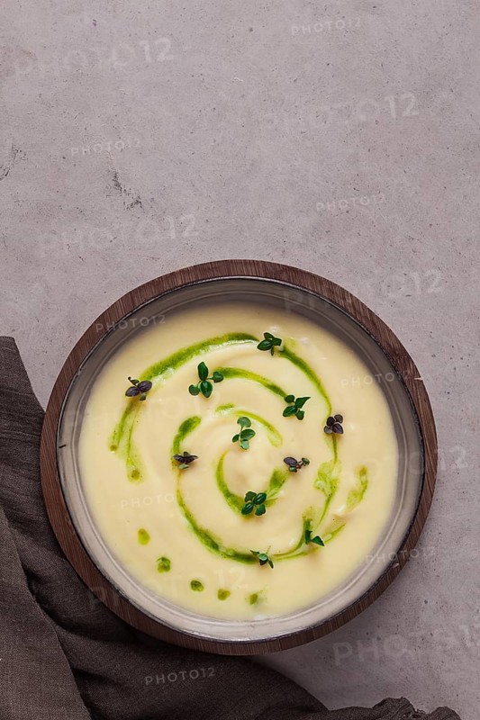 Mashed potatoes, with green butter and micro greenery, homemade, on a beige table, no people, top view