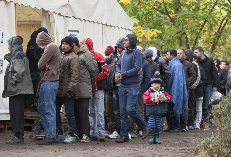 Refugees from Syria waiting to be registered at the Central Reception Centre for Asylum Seekers at the Berlin State Office for Health and Social Affairs, queue at the food counter, 09/10/2015