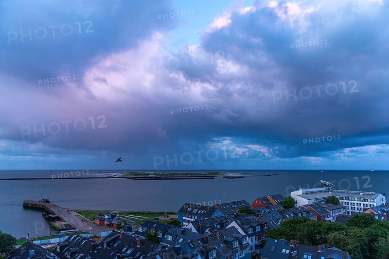 View from the upper land over the houses in the lower land to the Helgoland dune, Helgoland island, evening light, cloudy sky, North Sea, Pinneberg district, Schleswig-Holstein, Germany, Europe