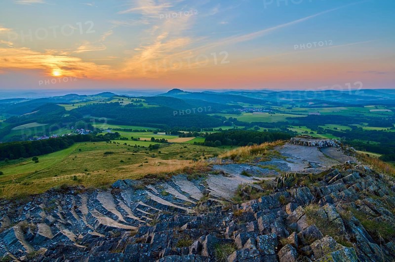 Panorama of a hilly landscape at sunset, showing fields and a cloudy sky, Abtsroder Kuppe, Abtsroda, Wasserkuppe, Rhön, Hesse, Germany, Europe