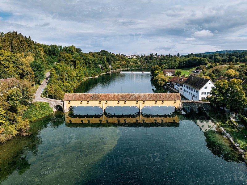 Aerial view of the covered Rhine bridge connecting the Swiss municipality of Rheinau and the German municipality of Altenburg. The bridge is one of the now rare Pfahljoch bridges in the canton of Zurich, Switzerland, Europe