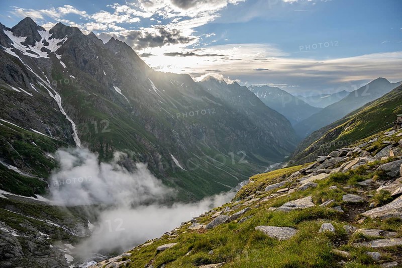 Atmospheric mountain landscape, clouds forming in a mountain valley in the evening light, Floitengrund valley, Greizer Hütte, Berliner Höhenweg, Zillertal Alps, Tyrol, Austria, Europe