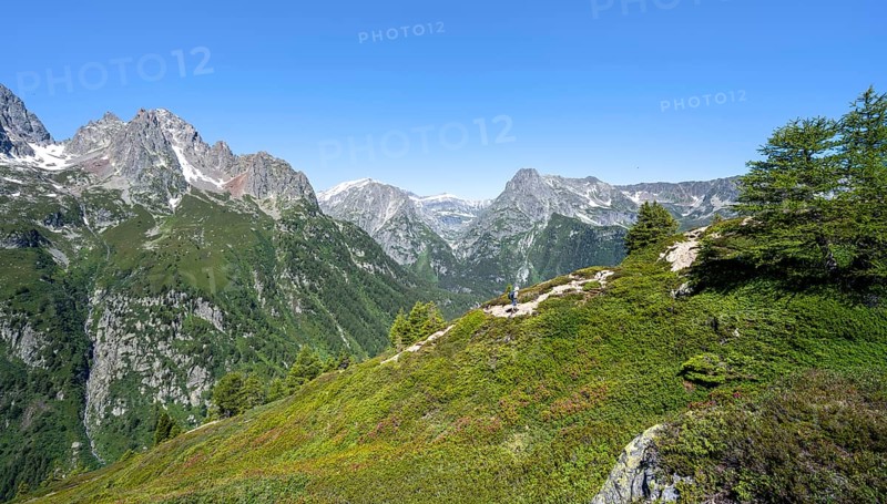 Mountaineer on hiking trail to Aiguillette des Posettes, mountain panorama with summit Mont Bues and Pointe de la Terasse, Chablais Alps, Chamonix, Haute-Savoie, France, Europe