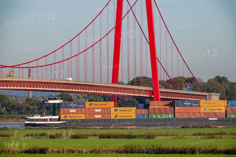 The Emmerich Rhine bridge, federal road B220, Germany's longest suspension bridge, is currently being renovated, bridge damage, container cargo ship on the Rhine, Lower Rhine, North Rhine-Westphalia, Germany, Europe
