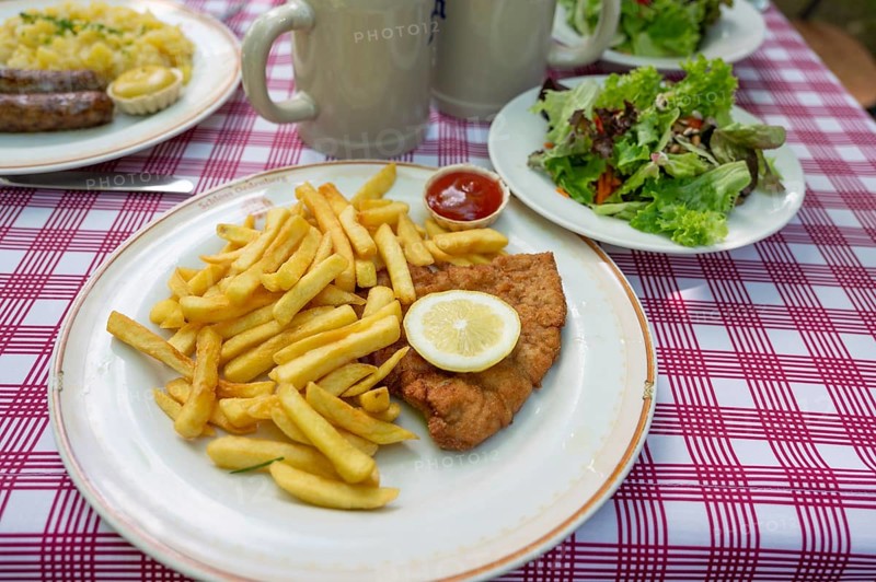 Schnitzel Wierner style with French fries and salad plate served in a garden restaurant, Franconia, Bavaria, Germany, Europe