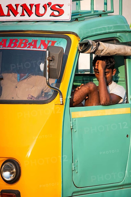 Young man in a yellow-green cargo rickshaw, Fort Cochin, Kochi, Kerala, South India, India, Asia