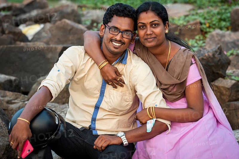 Woman hugging man with mobile phone, young married Indian couple, Fort Cochin, Kochi, Kerala, South India, India, Asia