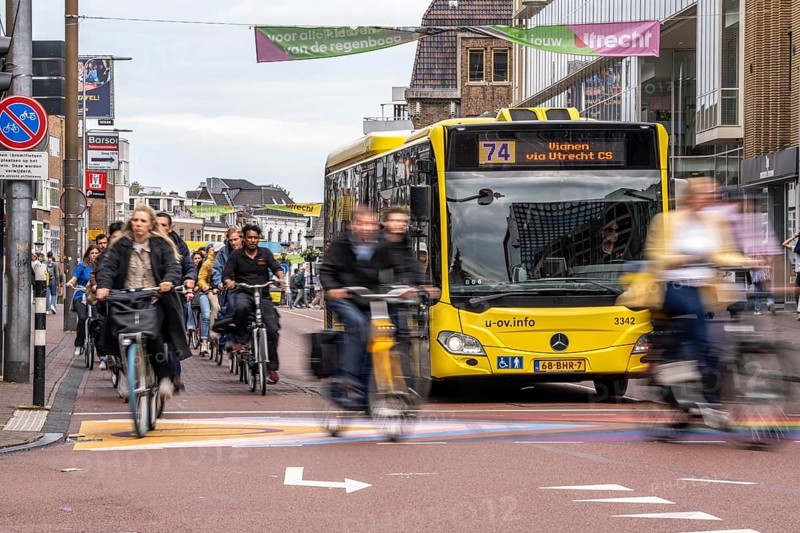 Central cycle path on the Lange Viestraat, in the centre of Utrecht, lanes for pedestrians, cyclists and cars are separated, heavy traffic, Netherlands