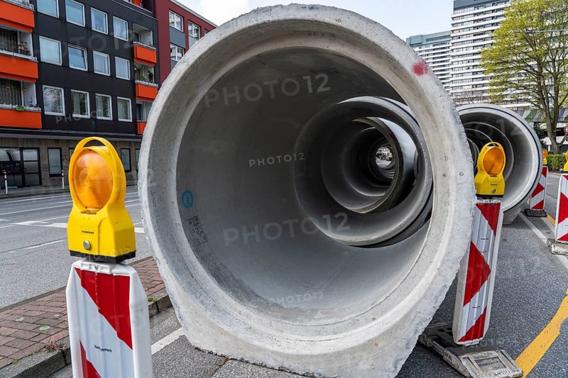 Concrete sewer pipes, stored on a construction site during sewer renovation work, on the Dickswall, city centre of Mülheim an der Ruhr, North Rhine-Westphalia, Germany, Europe