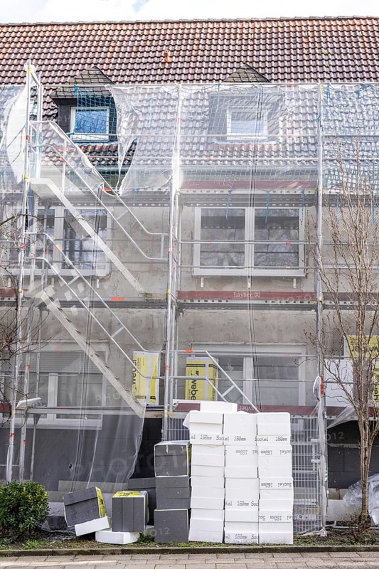 Energetic refurbishment of residential buildings, older apartment building is scaffolded, gets thermal insulation, Germany, Europe