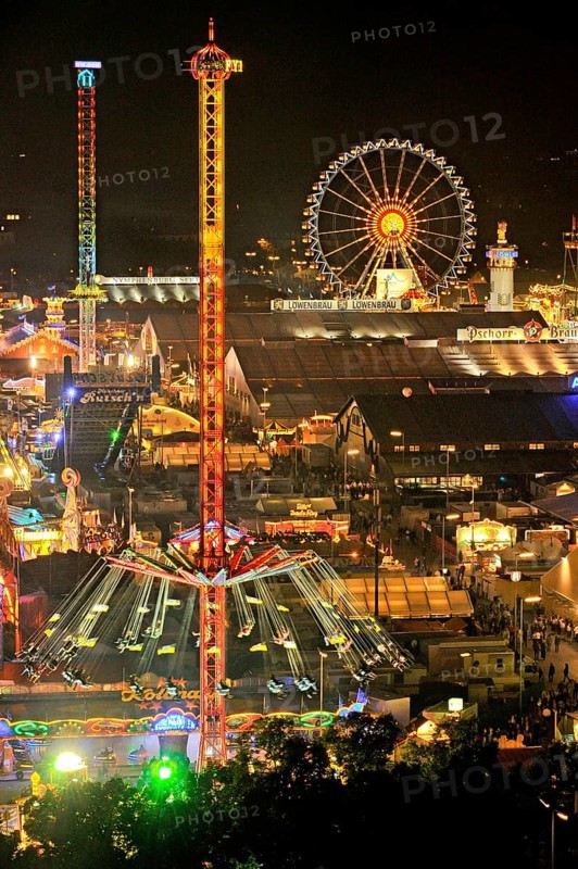 View over the Wies'n at night with illuminated carousel, Ferris wheel, stalls, beer tents and rides, Oktoberfest, Wiesn, Munich, Upper Bavaria, Bavaria, Germany, Europe