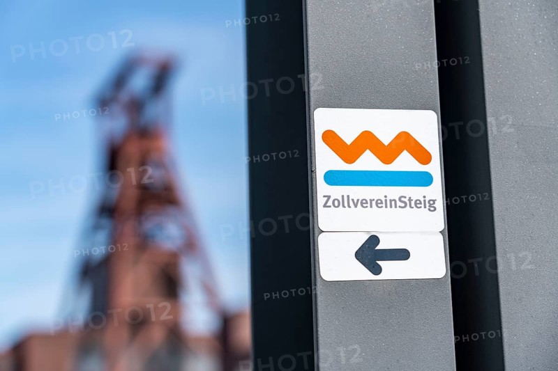 Zollverein Coal Mine Industrial Complex World Heritage Site, double trestle winding tower of shaft XII, hiking sign of the Zollvereinsteig, Essen, North Rhine-Westphalia, Germany, Europe