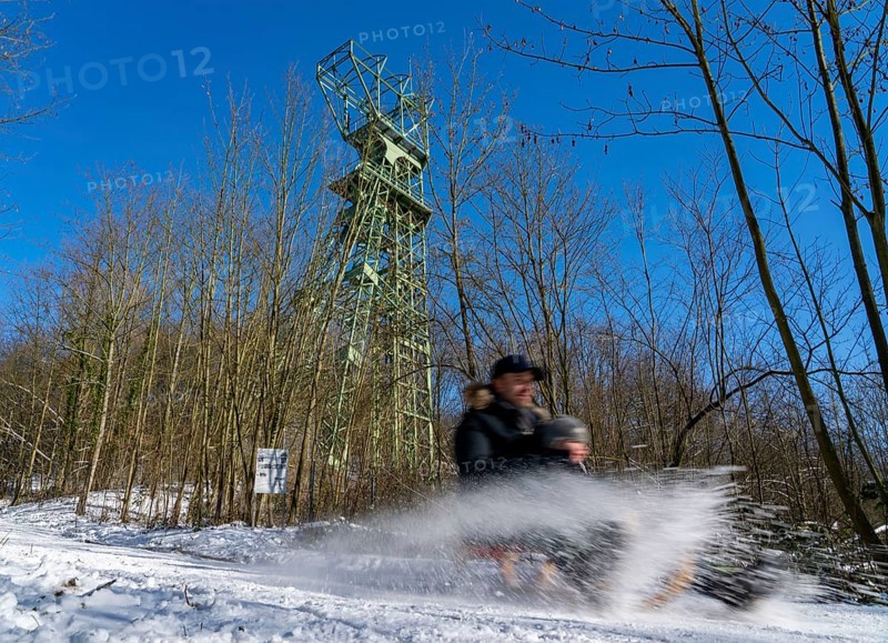 Winter in the Ruhr area, toboggan run on a forest path at Lake Baldeney, headframe of the former Carl Funke colliery, Essen, North Rhine-Westphalia, Germany, Europe