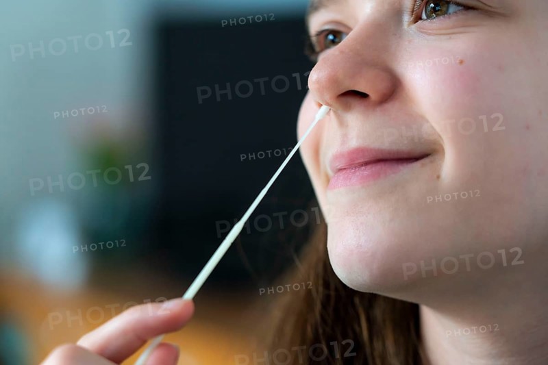 Corona antigen rapid test, lay test, self-test, for the detection of SARS-CoV-2 infection, swab in the nose during sampling, young girl