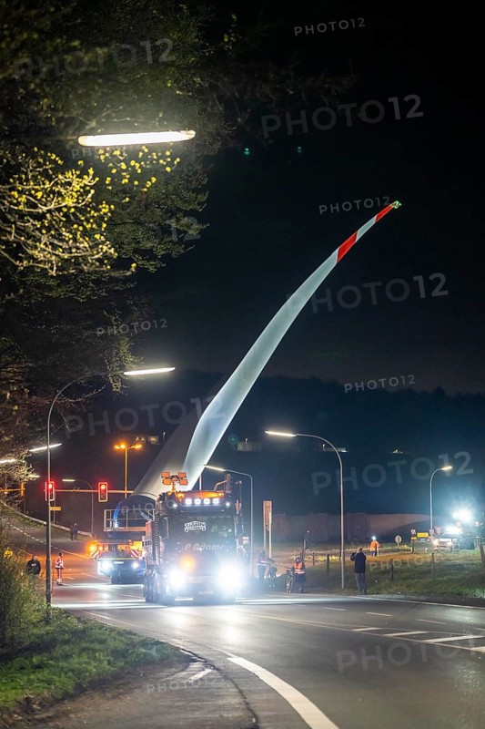 Transport of a 68 metre long, 22 tonne blade of a wind turbine, here in Schwelm, with a self-propelled Blade-Lifter vehicle, over a 40 km long route, over 2 nights, in the Bergisches Land, through towns, villages, over country roads, narrow through roads, to the construction site of the wind turbine near Hagen, North Rhine-Westphalia, Germany, Europe