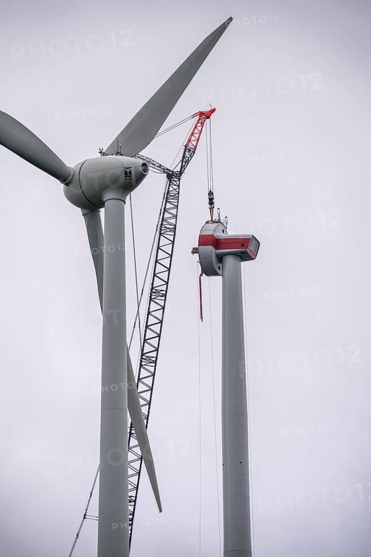 Erection of a wind turbine, wind energy plant, assembly of the ring generator, with a crawler lattice crane, wind farm near Hagen, North Rhine-Westphalia, Germany, Europe