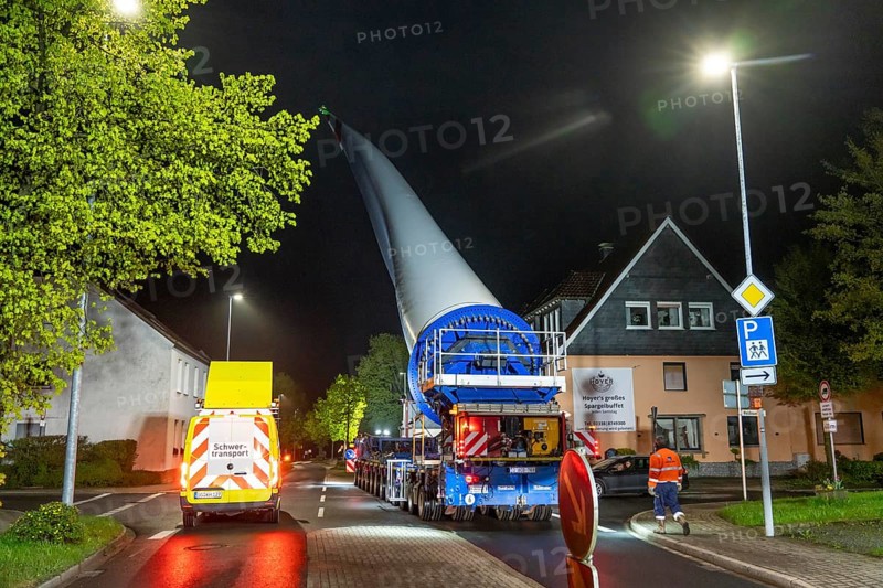 Transport of a 68 metre long, 22 tonne blade of a wind turbine, here in Breckerfeld-Waldbauer, with a self-propelled Blade-Lifter vehicle, over a 40 km long route, over 2 nights, in the Bergisches Land, through towns, villages, on country roads, narrow through roads, to the construction site of the wind turbine near Hagen, North Rhine-Westphalia, Germany, Europe