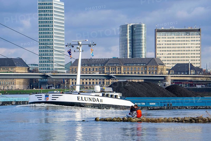 The Rhine near Düsseldorf, cargo ship, coal freighter, skyline, Rhine knee bridge, North Rhine-Westphalia, Germany, Europe