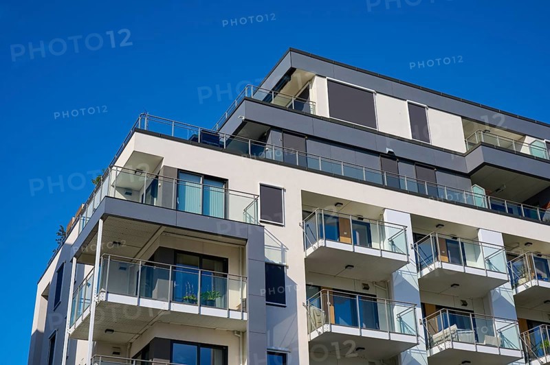 Modern residential building with several balconies and a façade under a clear blue sky, Molde, Romsdal, Norway, Europe