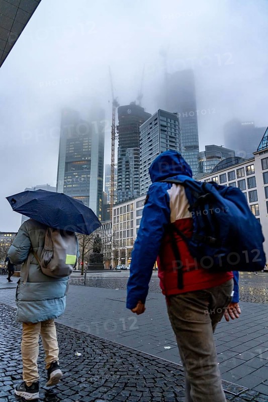 Rainy weather, freezing rain, Goetheplatz, high-rise skyline in clouds, passers-by hurrying through the damp, icy weather, Frankfurt am Main, Hesse, Germany, Europe