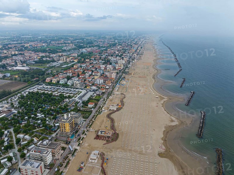 Bathing beach in Rimini. Bathing beach on the Adriatic in bad weather. All deckchairs are free. Drone photo. Rimini, Province of Rimini, Italy, Europe