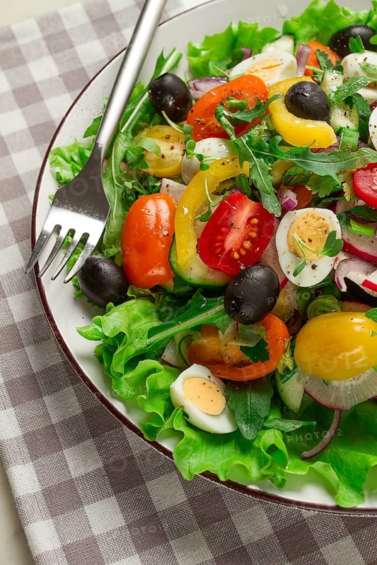 Vegetable salad, with quail eggs and olives, fresh, close-up, no people