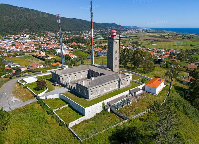 Lighthouse and other buildings in a hilly landscape with a village and the sea in the background, aerial view, Montedor, Viana do Castelo, Portugal, Europe