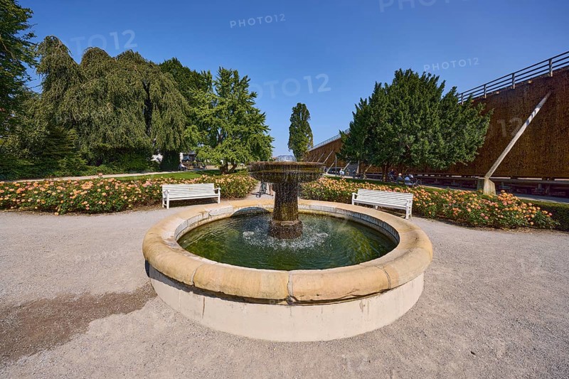 Fountain with benches, graduation tower and trees in the rose garden park in Bad Salzuflen, Lippe district, North Rhine-Westphalia, Germany, Europe