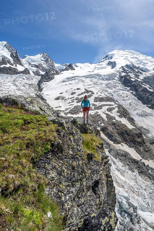 Mountaineer in front of a glacier, High alpine glaciated mountain landscape, La Jonction, Glacier des Bossons meets Glacier de Taconnaz, Summit of Mont Maudit and Mont Blanc, Chamonix, Haute-Savoie, France, Europe