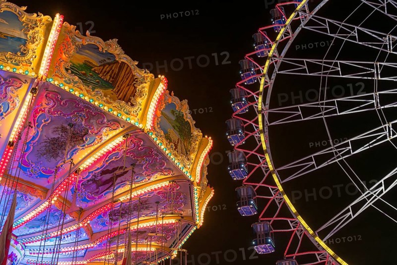 A funfair at night with illuminated chain carousel and Ferris wheel, Europa Rad, rides, wave flight, Cannstatter Wasen, folk festival, Bad Cannstatt, Stuttgart, Baden-Württemberg, Germany, Europe