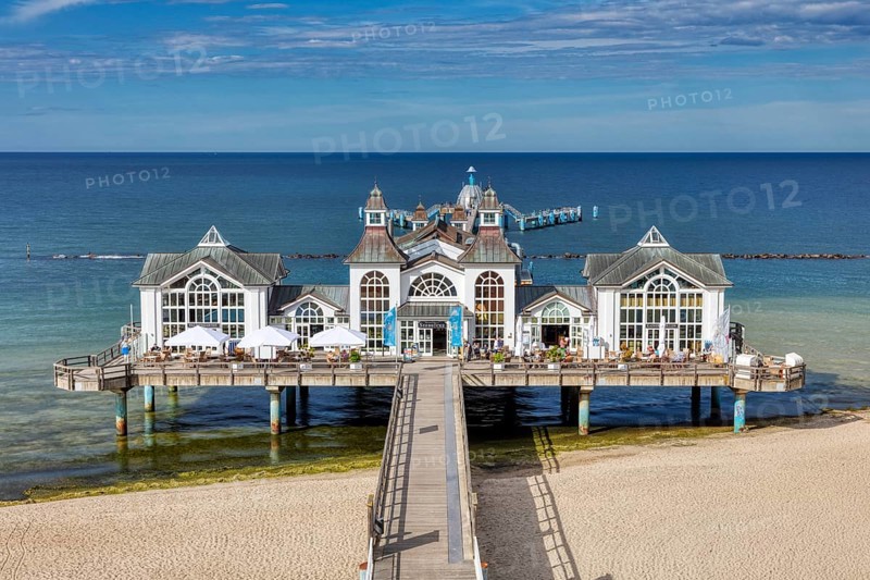 Impressive pier with white pavilions and a relaxed beach atmosphere, Rügen