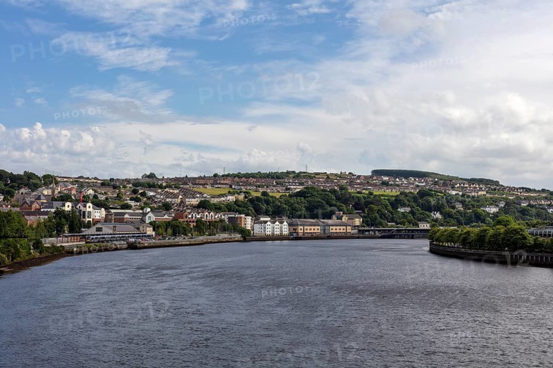 River with neighbouring city under blue sky and clouds, Londonderry