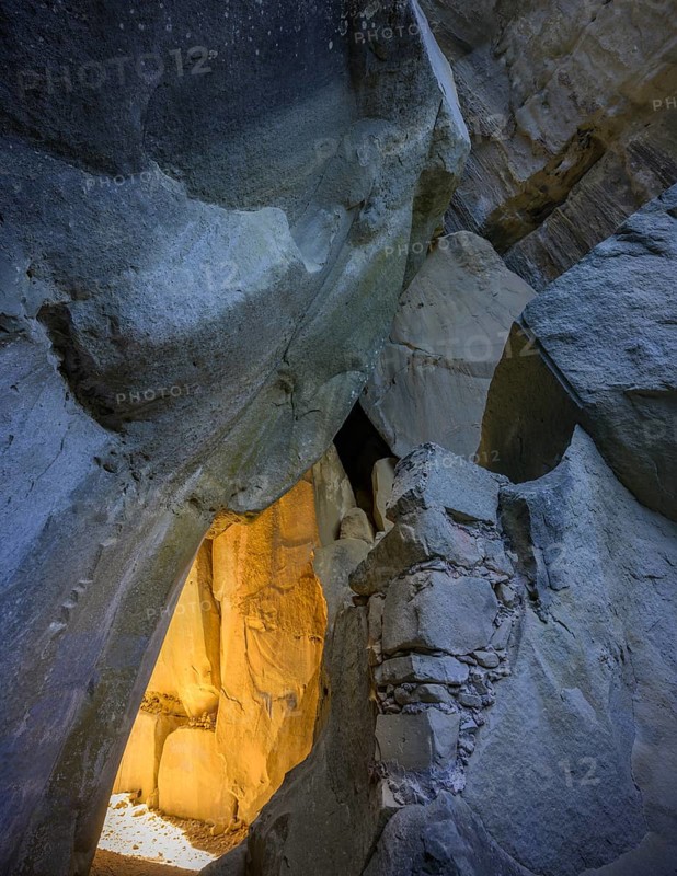 Incidental sun illuminates the passage (Chambre du Roi) through the high rocks, hike through the sandstone labyrinth Grés d'Annot, Alpes-de-Haute-Provence, France, Europe