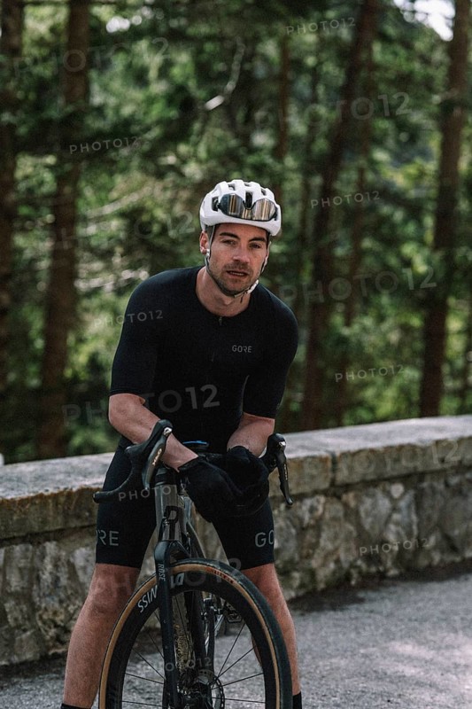 Road bike rider in spring in the Allgäu against the picturesque backdrop of the Alps, Bavaria, Germany, Europe
